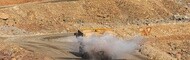 Water trucks spray dust on haul roads to help improve mine safety and driving conditions in surface mine sites.
