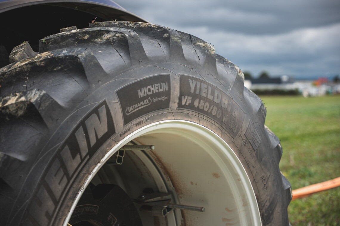 Closeup of the sidewall of a Michelin Yieldbib tire mounted on a tractor in a field
