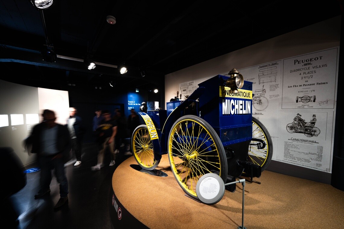 An antique replica of the 1895 Michelin 'L'Éclair' car, the first on pneumatic tires.