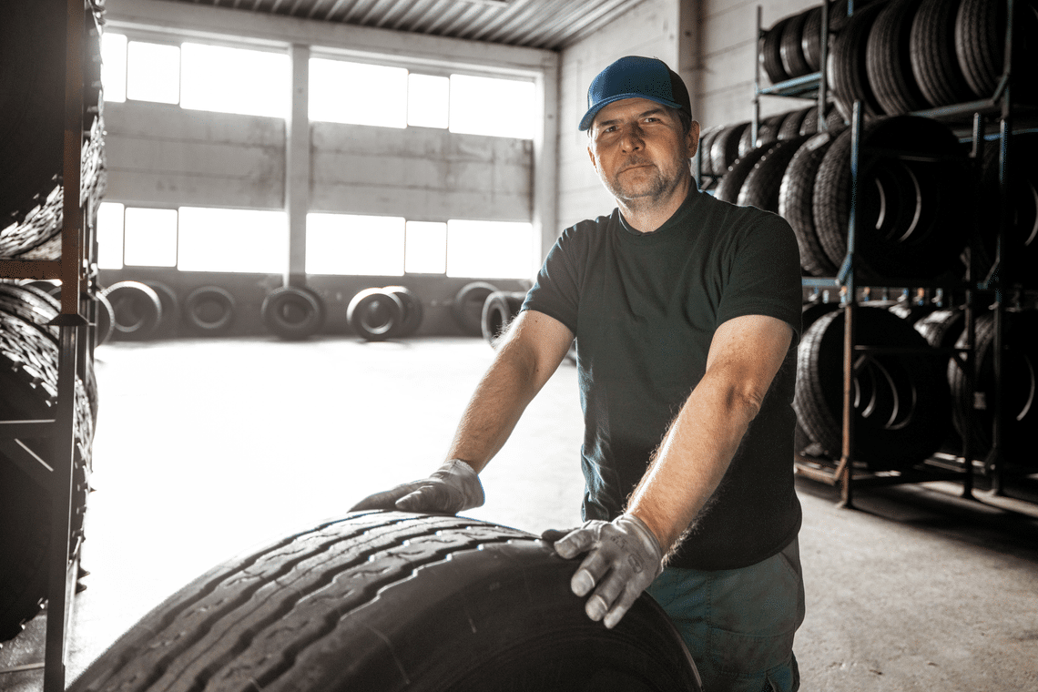 Truck tyre retreading technician working in a workshop