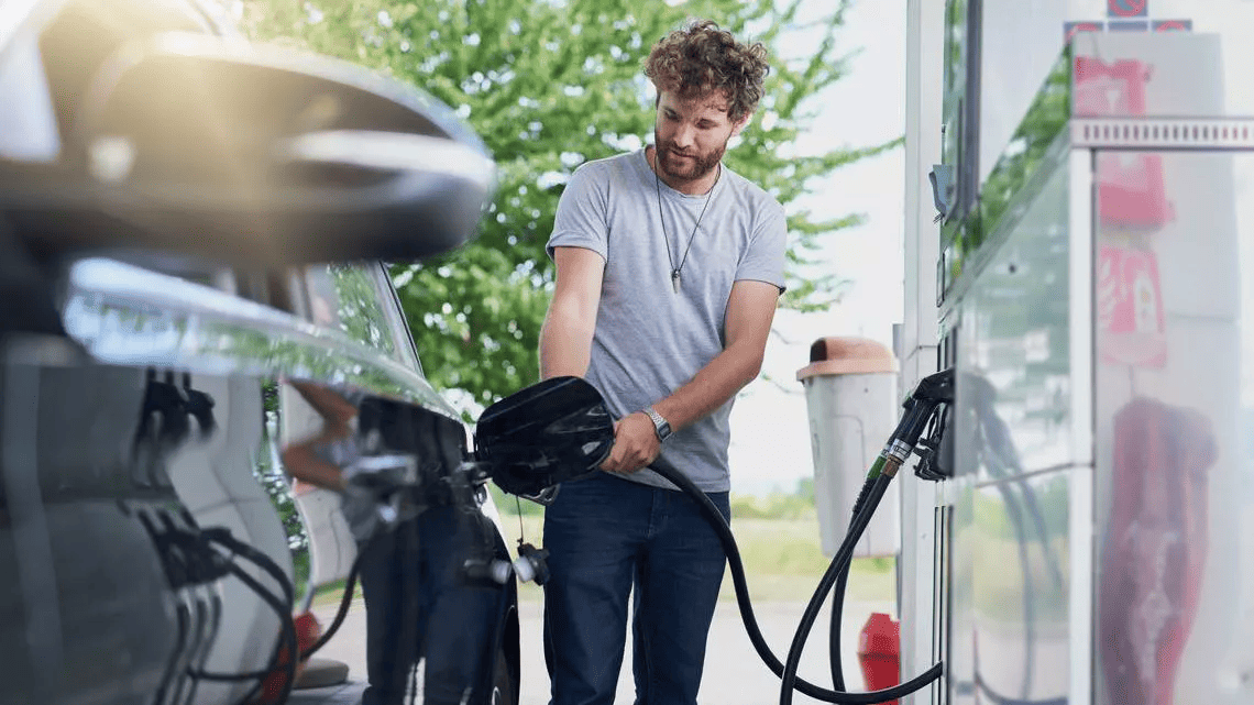 A man refueling petrol at a petrol station. Drive higher energy efficiency with quality tyres.
