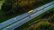 Photography of a road with a yellow truck