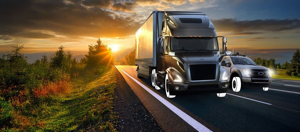 Semi truck and Light duty truck on highway with white overlay tires