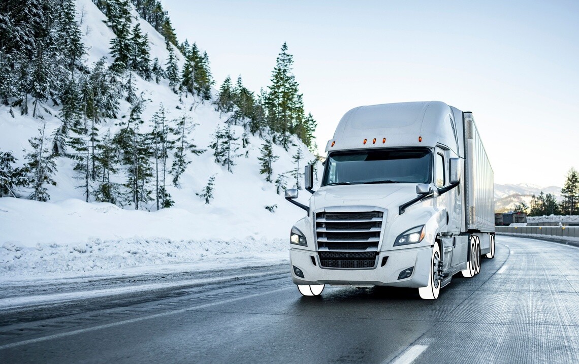White cab semi truck on a highway with snow and has white overlay tires