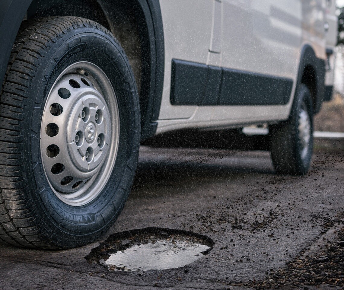 Michelin Agilis CrossClimate tire on a van navigating a pothole