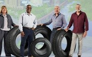 Commercial fleet professionals standing with Michelin tires in front of a city backdrop representing mobility, transportation, and fleet operations.