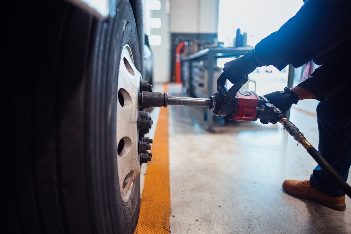 Technician performing proactive tire maintenance on a commercial fleet vehicle as part of Michelin Fleet Solutions Tires as a Service program