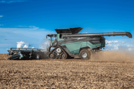combine harvester with tracks in a field