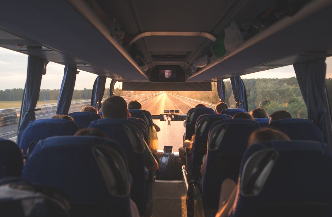 Passengers traveling on a motor coach along a highway
