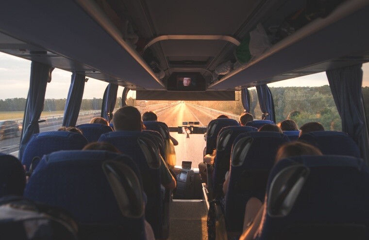 Passengers traveling on a motor coach along a highway
