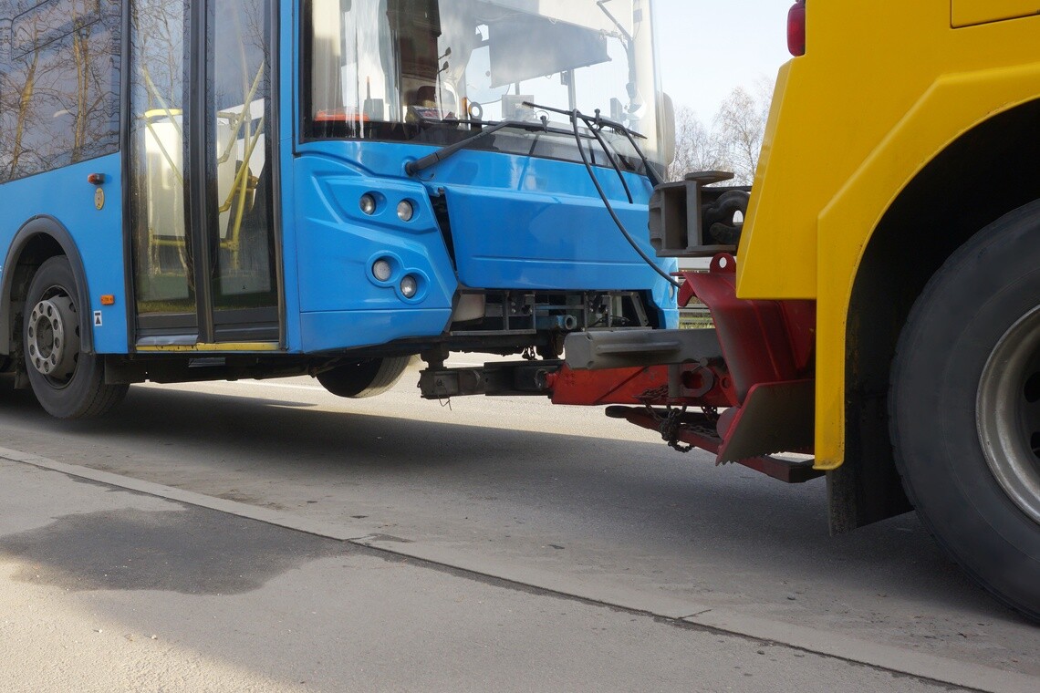 Passenger bus receiving roadside assistance from a service vehicle