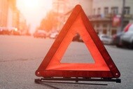 Roadside warning triangle placed on the road during a vehicle breakdown