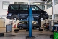 Passenger van on a vehicle lift during preventive maintenance service
