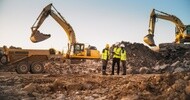 Construction crew with heavy equipment operating on a rugged worksite