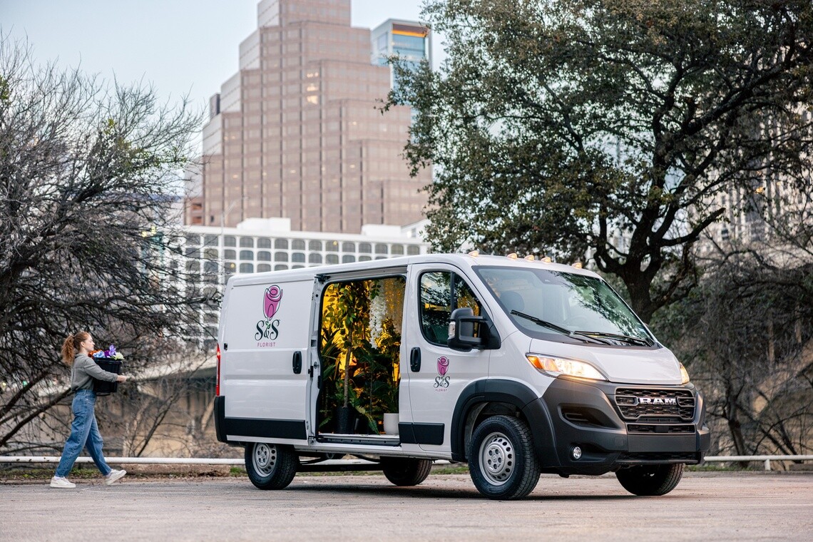 Florist loading flowers into a commercial work van for a delivery