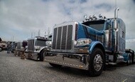 Commercial trucks lined up at an outdoor truck show