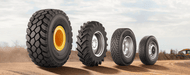 a lineup of Michelin commercial tires featuring a construction tire, agricultural tire, semi truck tire and light-duty truck tire.