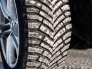 Close up of MICHELIN X-ICE NORTH 4 winter tires with snow