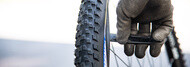 slide the tyre levers along the rim to remove the first bead from the tyre