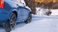 View of car with winter tires on the snow covered road.