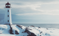 View of a lighthouse on the water during winter in Nova Scotia