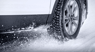 Close up of tire rolling through the snow.